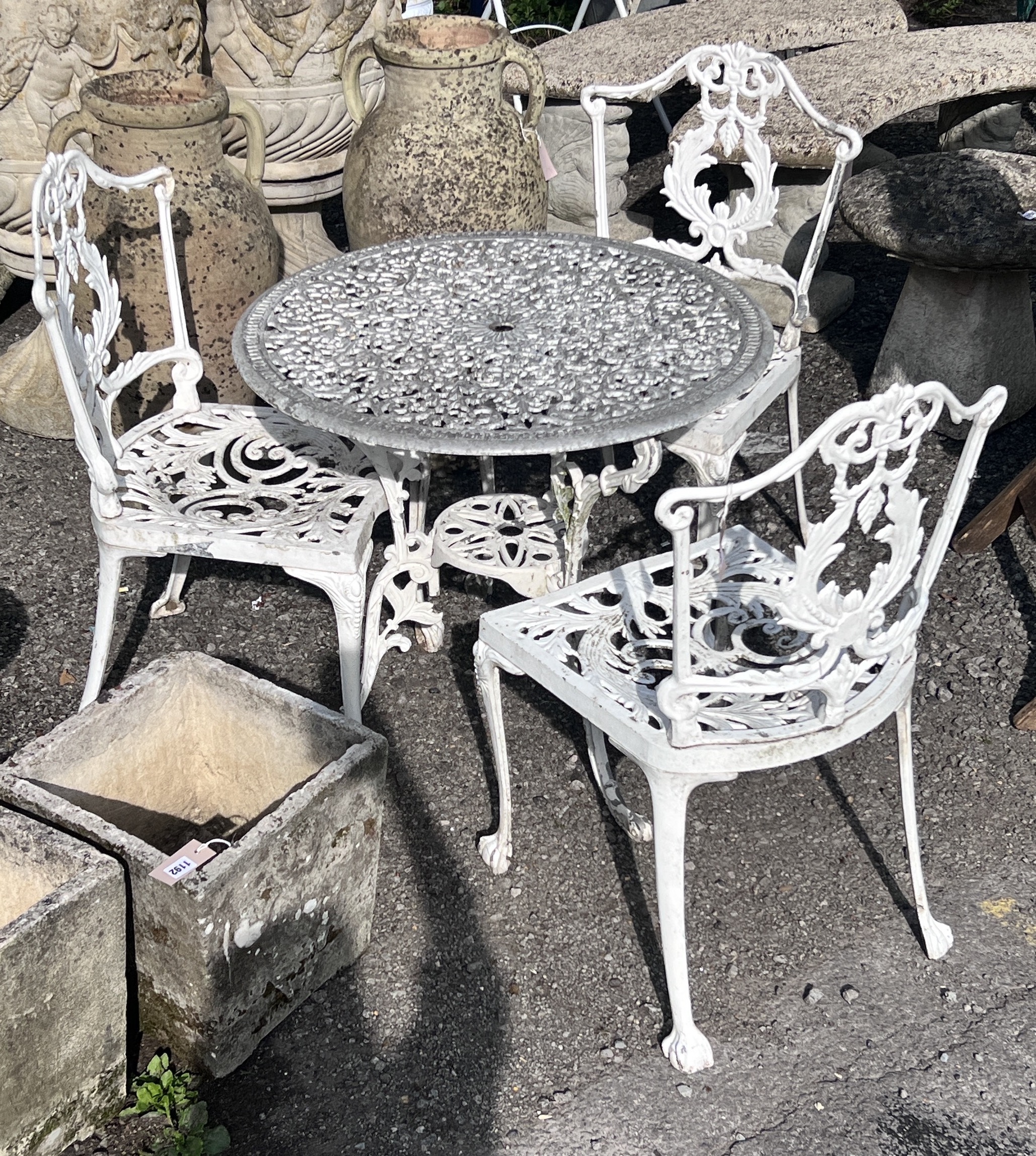 A Victorian style circular painted aluminium garden table, diameter 72cm, height 65cm, and three chairs